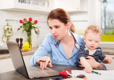 53061475 – young mother working with her baby at home
